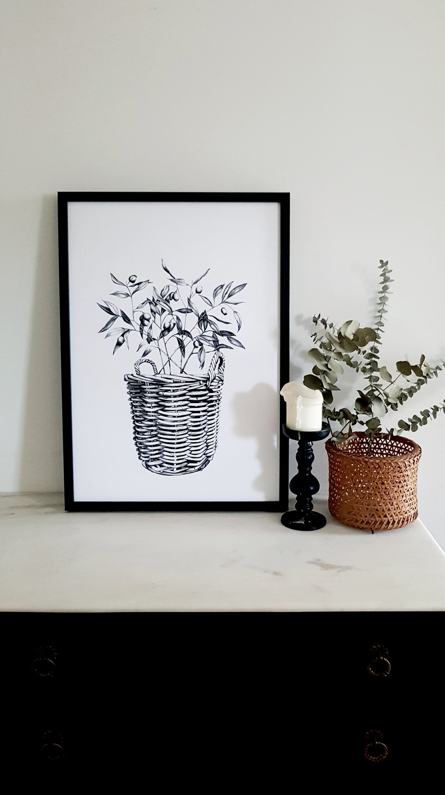 Hand drawn using pencil, in meticulous details with gum leaves inside the basket, art print in black frame