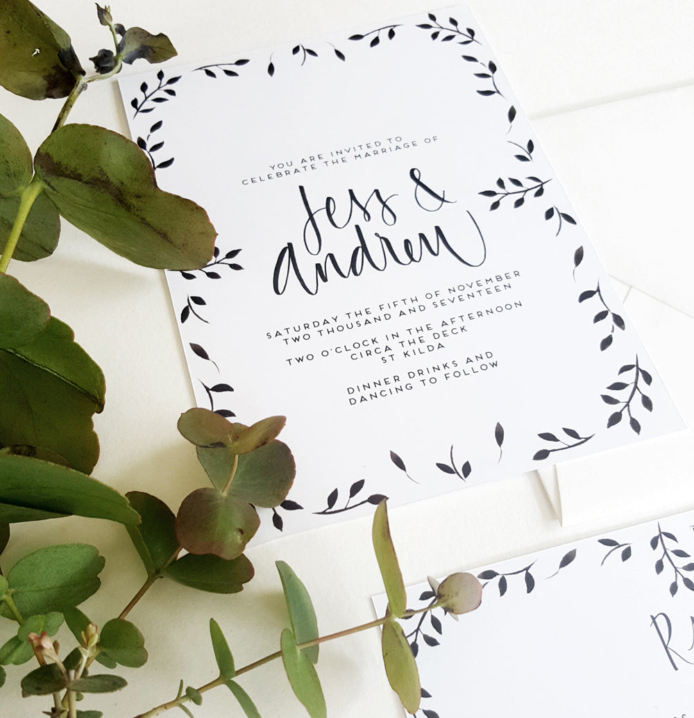 Black symetrical leafy invite design, hand painted leaves that create a border around the invite, with text in the middle